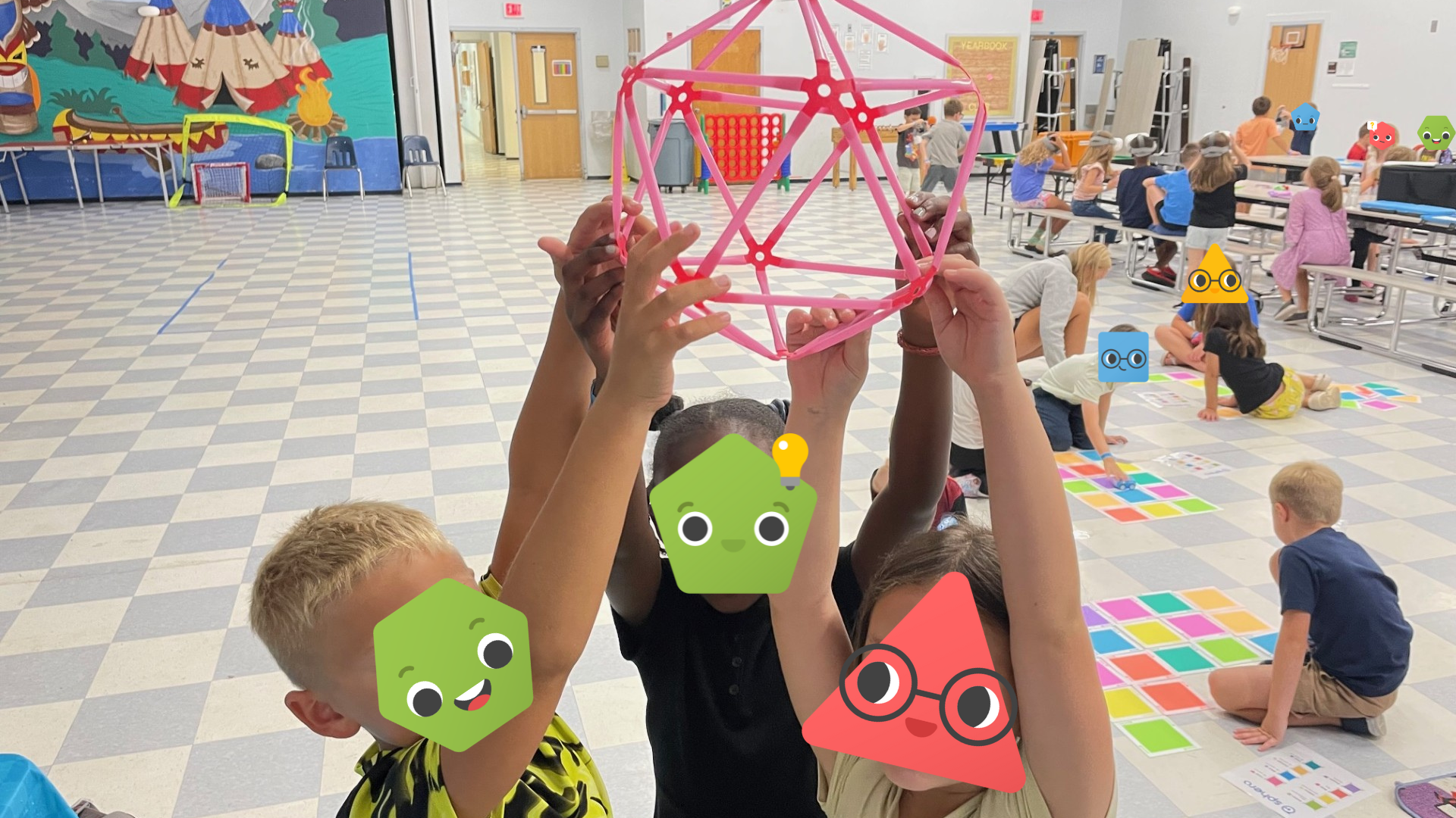 A group of students holding up a Strawbees build.