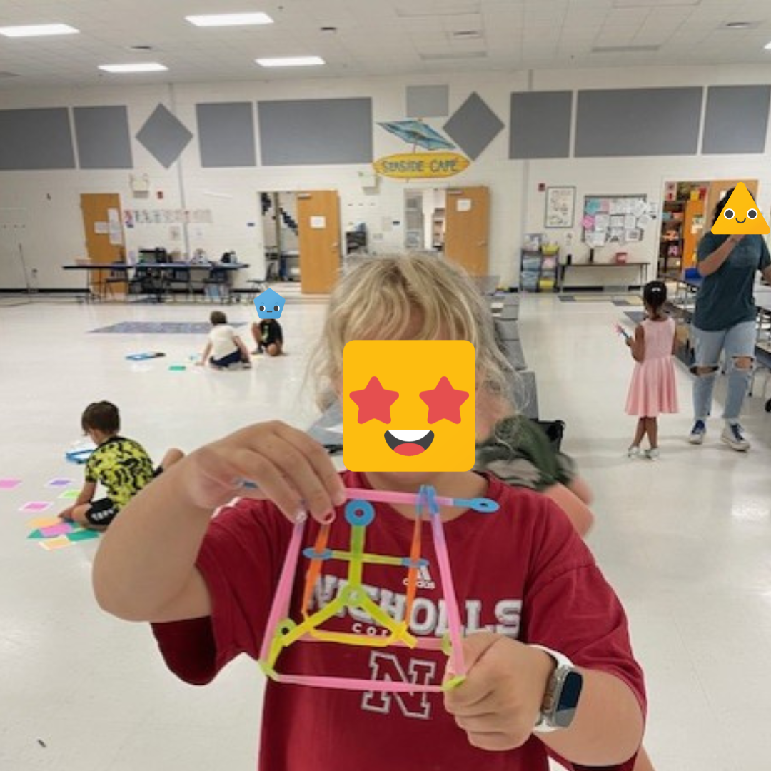 One student displaying their Strawbees build.