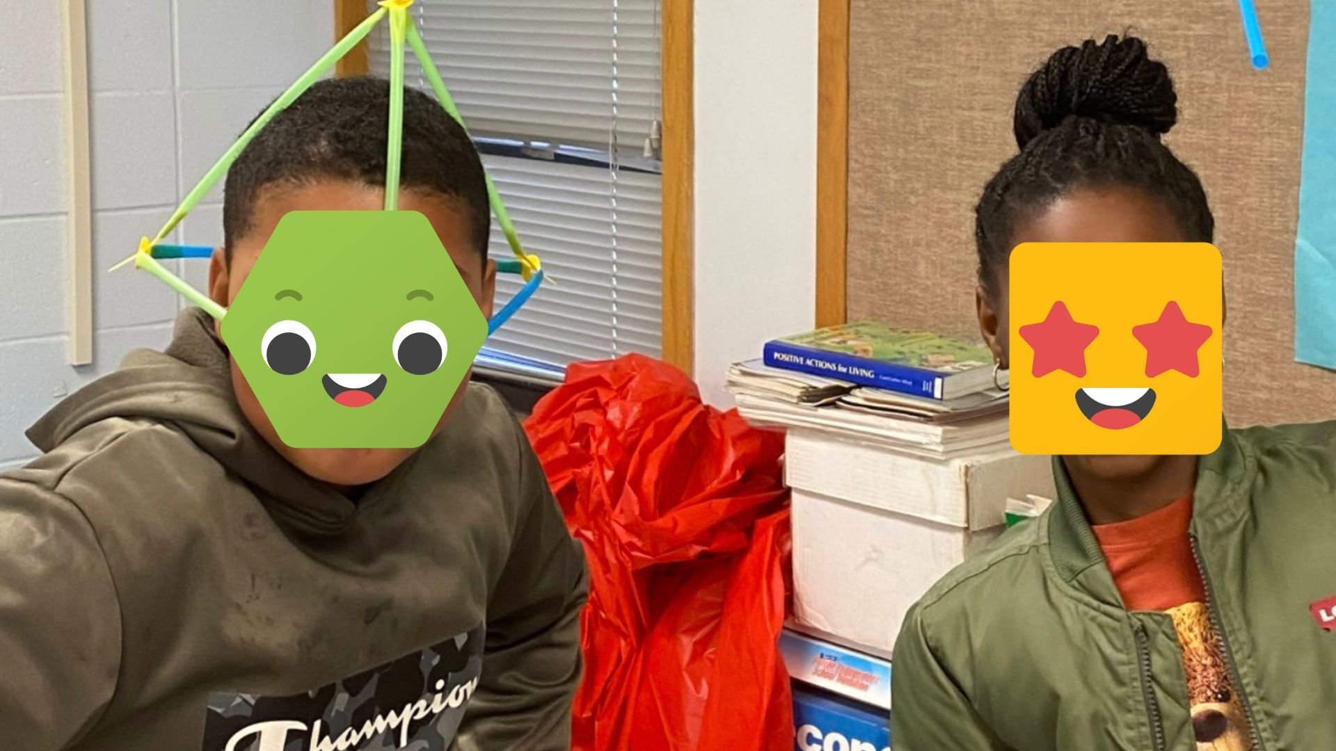 Two students posing with Strawbees.